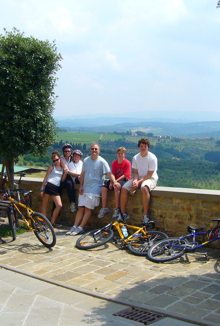 Happy family enjoying a bike tour in Tuscany